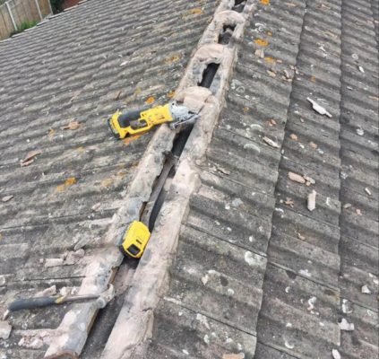 Roofing tools on exposed roof beams during roof repair work in Guildford, UK.